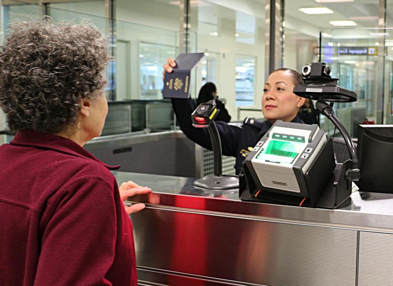 CBP officer inspecting an international traveler.