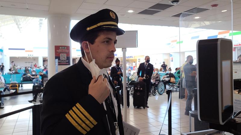 A pilot has his image taken before boarding a departing flight. 