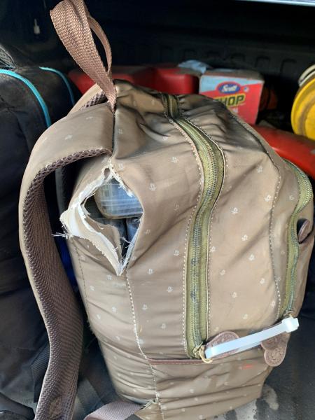 A cocaine brick is visible inside a backpack. 
