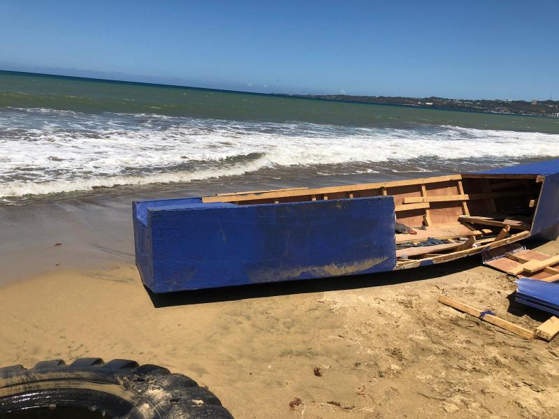 The wooden vessel used by aliens breaks in the shoreline.  