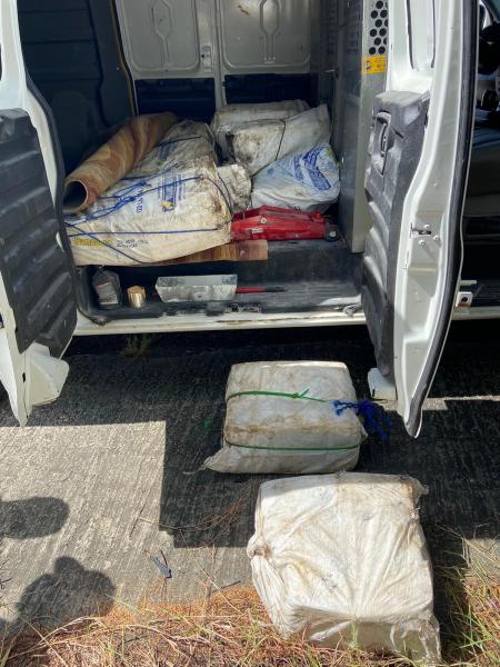 Bales are cocaine are visible in a van that was intercepted. 