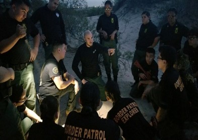 Border Patrol Agent briefs Explorers on safety strategies for tracking in low light conditions.
