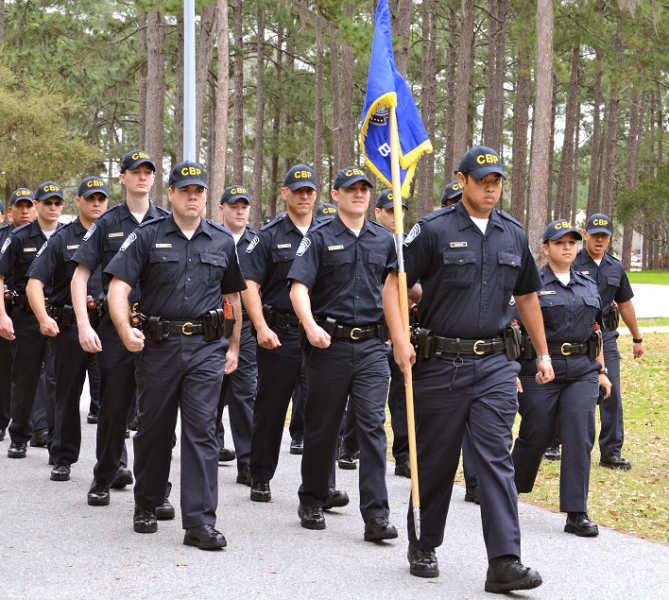 CBP Officer Trainees marching in formation as part of drill and ceremony.