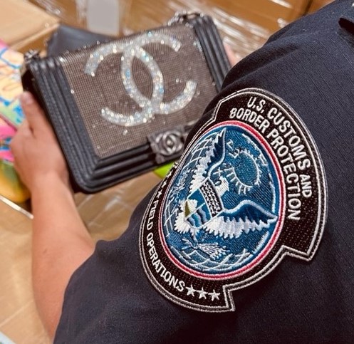 CBP Officer inspecting a fake purse
