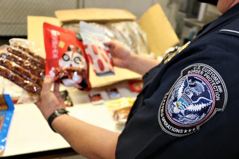 Agriculture Specialist inspects Animal Food Contraband 