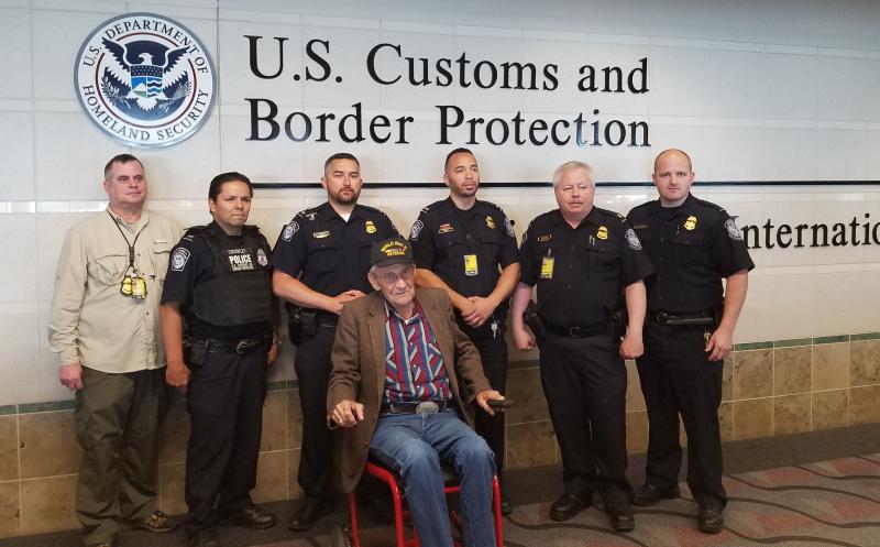CBP officers in Minneapolis pose with D-Day  hero Willard LaCounte. LaCounte landed in  Normandy on June 7, 1944 and was inducted into  the French Legion of Honor during the 75th  D-Day anniversary.