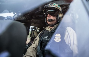 Photograph of Air Interdiction Agent inside a helicopter. Click photo for more information on Air and Marine Operations