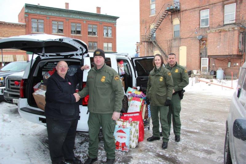  U.S. Border Patrol agents representing Houlton Sector delivered an SUV full of Christmas wishes for local children to Salvation volunteer John Labelle