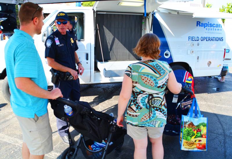 Children and parents learn about CBP inspection truck